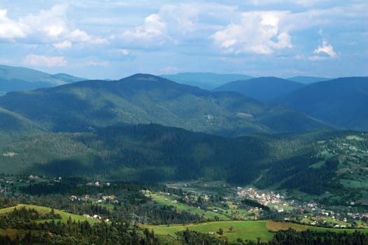 Panorama of Carpathian village with mountains and sky
