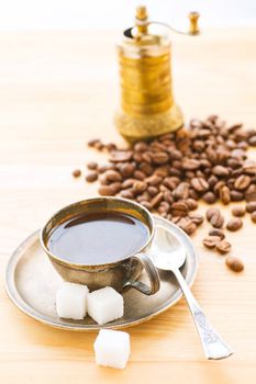 A cup of coffe with coffee bean as background. Vertical view