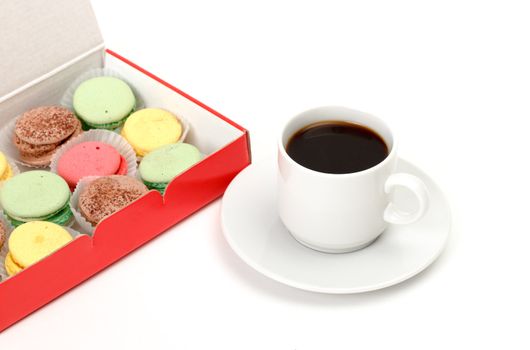 Colorful Macaroon and cup of coffee on white background