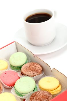 Colorful Macaroon and cup of coffee on white background