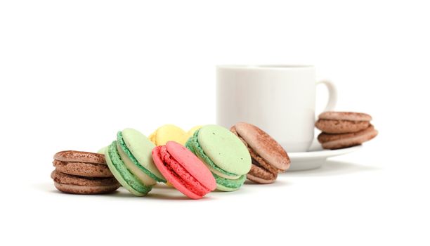 Colorful Macaroon and cup of coffee on white background