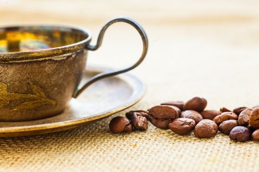A cup of coffe with coffee bean as background.