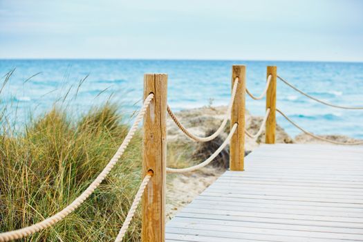Beautiful wooden road - path to beach into osean