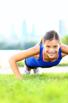 Exercise woman doing situps in outdoor workout training. Asian sport fitness woman smiling cheerful and happy looking at camera.