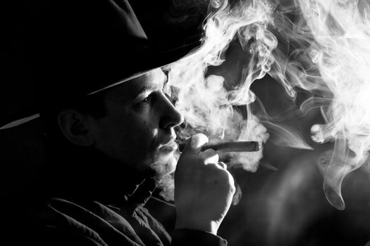 Black and white images of a man in clubs of smoke