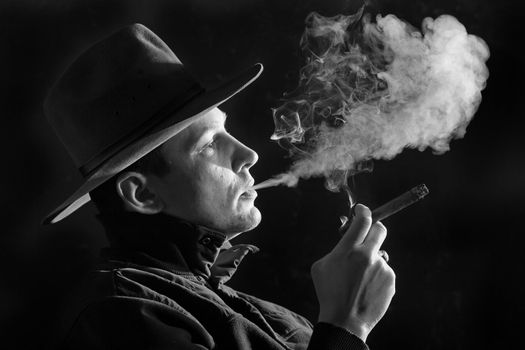 An black and white image of a man in felt hat