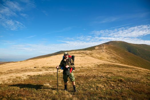 An image of a  man walking in mountains