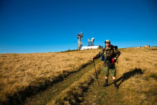 An image of a tourist walking in mountains