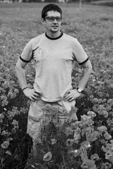 An image of a man in a field with poppies