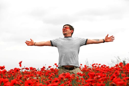 An image of a man in a field with poppies