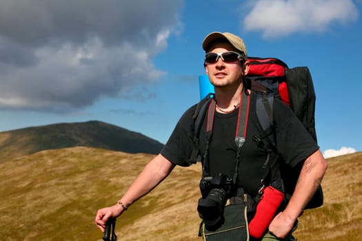 An image of a tourist walking in mountains