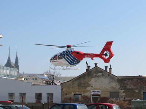 Helicopter flying high in the blue sky