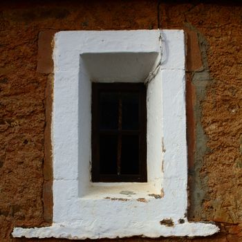 The window of an old church in the Spanish countryside.