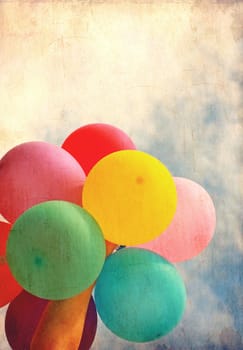 Female holding multicolored balloons with blue sky, photo in old image style