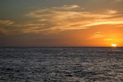 Sunset over a calm pacific ocean