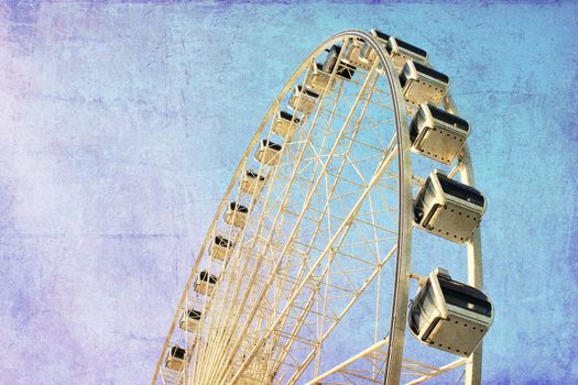 Ferris wheel with blue sky, photo in old image style