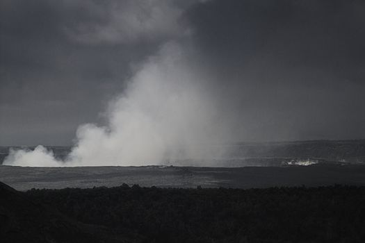Steaming hole of the kilauea volcano during a cloudy day in black and white