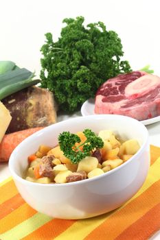 a bowl of turnip stew with parsley and cook meat