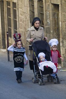 JERUSALEM - MARS 08 : Ultra Orthodox family during Purim in Mea Shearim Jerusalem on Mars 09 2012 , Purim is a Jewish holiday celebrates the salvation of the jews from jenocide in ancient Persia
