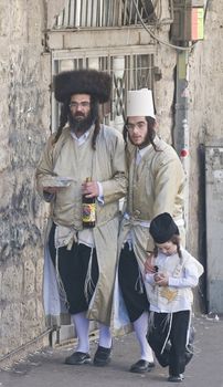 JERUSALEM - MARS 09 : Ultra Orthodox family during Purim in Mea Shearim Jerusalem on Mars 09 2012 , Purim is a Jewish holiday celebrates the salvation of the jews from jenocide in ancient Persia
