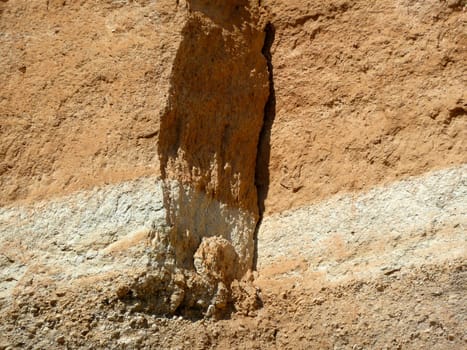 colored minerals in stripes on a cliff face