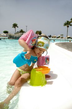 Child is playing by pool