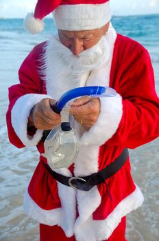 Santa claus is on vacation. He is getting ready to go and dive in the water.
