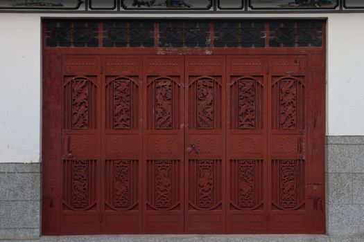 A decorated red door in China.