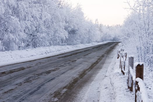 dirty winter snow bound road is in the country