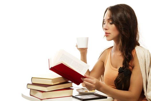 beautiful woman drinking coffee while reading book on white background