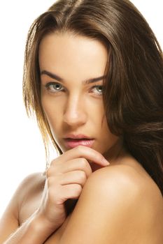 portrait of a gorgeous woman holding hand to her chin on white background