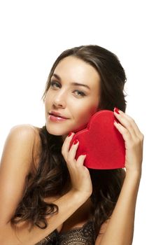 beautiful woman holding red heart on white background