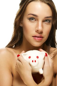 beautiful woman holding piggy bank on white background