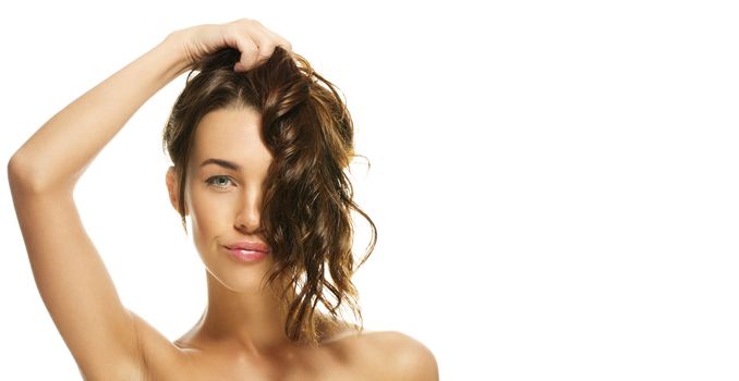 portrait of a beautiful woman holding her hair on white background