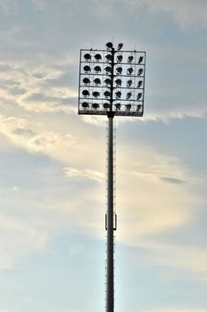 Sport light tower for arena with cloudy sky