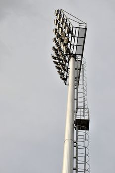 Sport light tower for arena with cloudy sky