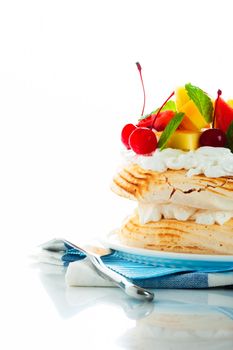 Pavlova with fresh fruit (mango, pineapple, watermelon, cherry) ready  to serve, on white background as a studio shot