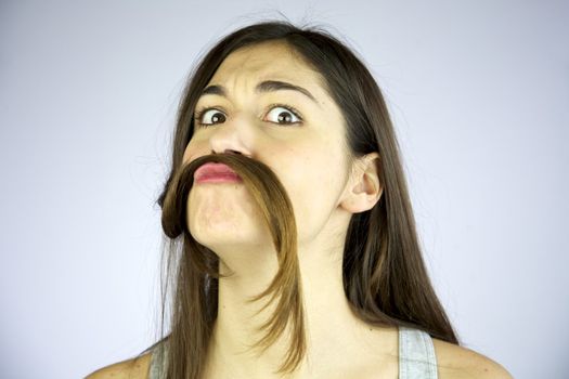 funny girl making mustache of her long hair