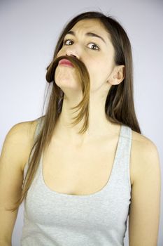 Funny girl making mustache with her very long hair