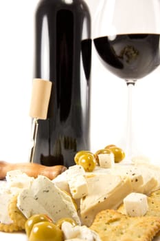 Picture of red wine, crackers, cheese and olives