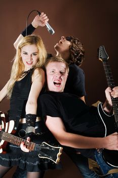 Funny rock band playing in photostudio