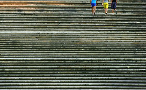Rows of stairs with anonymous people legs