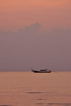 Silhouette fishing boat in the morning at Surin island national park in Thailand