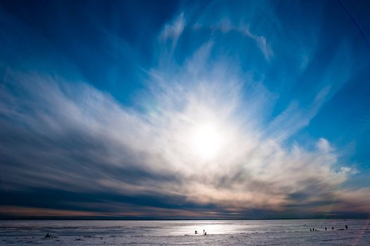 Beautiful cloudy and blue sky over ice lake in Saint-Petersburg, Russia