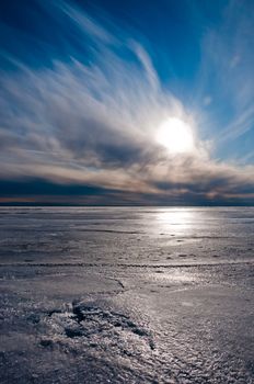 Beautiful blue and cloudy sky over ice lake in Saint-Petersburg, Russia