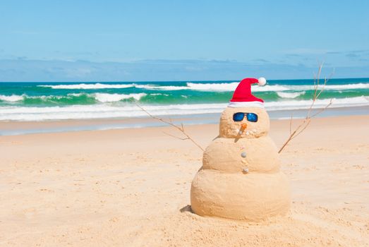 Snowman on holidays made out of sand instead of snow. Concept could be used for Global Warming &amp; Christmas Cards