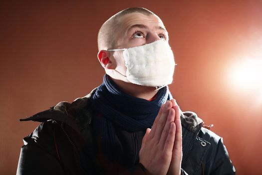 A man in a protective mask on brown background