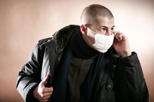 An image of a young man in medical mask