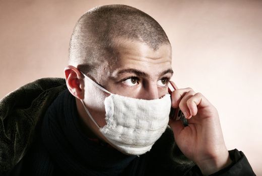 A man with a protective mask on brown background