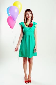 An image of young woman with birthday balloons